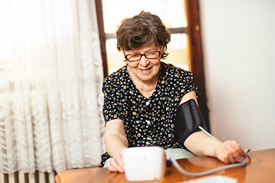 An older lady checking her blood pressure