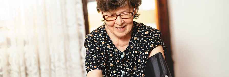 An older lady checking her blood pressure