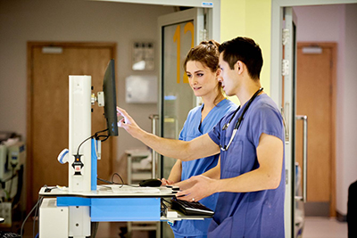 NHS staff working on a computer