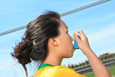 Young girl with an asthma inhaler